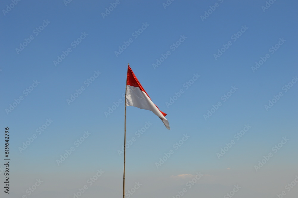 Fototapeta premium Indonesian Flag with the beautiful blue sky