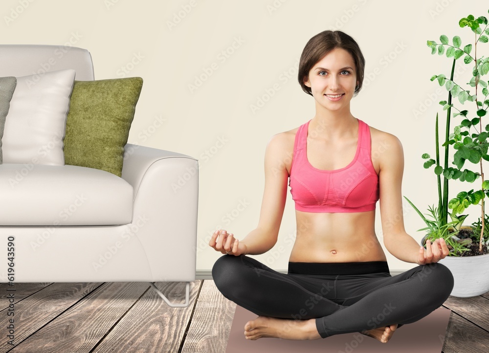 Pretty young female practicing yoga