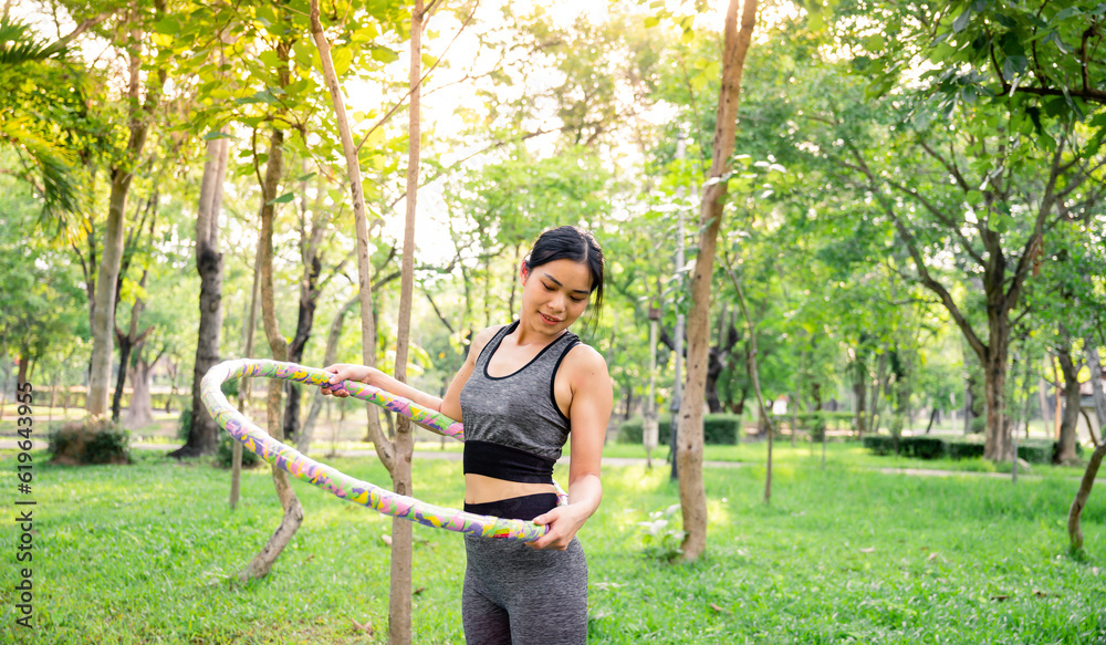 Exercising with Hula Hoop in the park Exercising with Hula Hoop in the park
