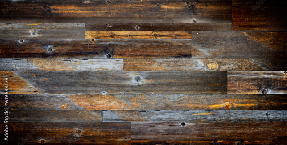 Dark stained reclaimed wood surface with aged boards lined up. Wooden