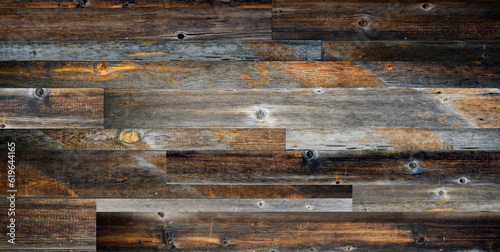 Dark stained reclaimed wood surface with aged boards lined up. Wooden floor planks with grain and texture.