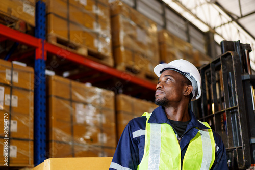 Portrait of smart good looking African - American Black warehouse staff - worker working in warehouse.