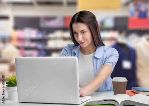 Young student woman writing or working on laptop