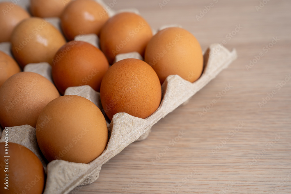 Fresh Chicken eggs in carton box on wooden table. From natural organic farm Fresh Chicken eggs in carton box on wooden table. From natural organic farm