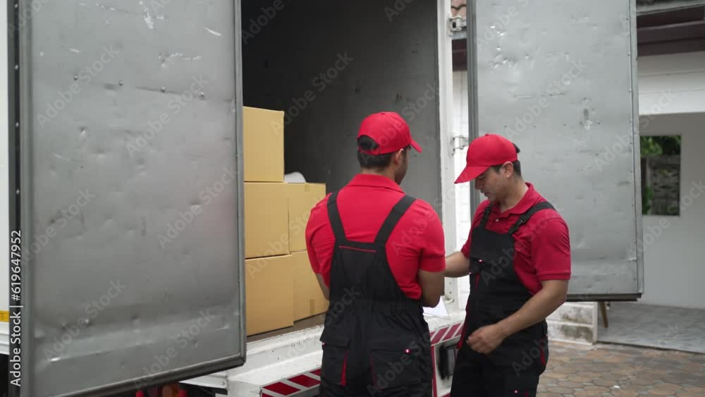 Delivery man move items to the house. Delivery man move items to the house.