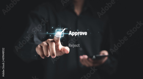 Approve concept. businessman touching check mark to approve document or project on virtual screen.