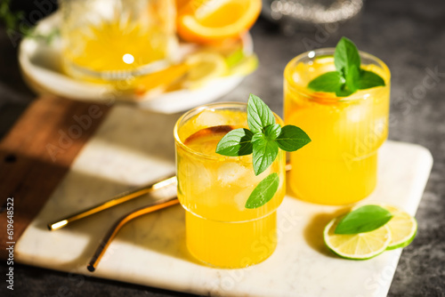 Lemonade or mojito cocktail with fruits and basil