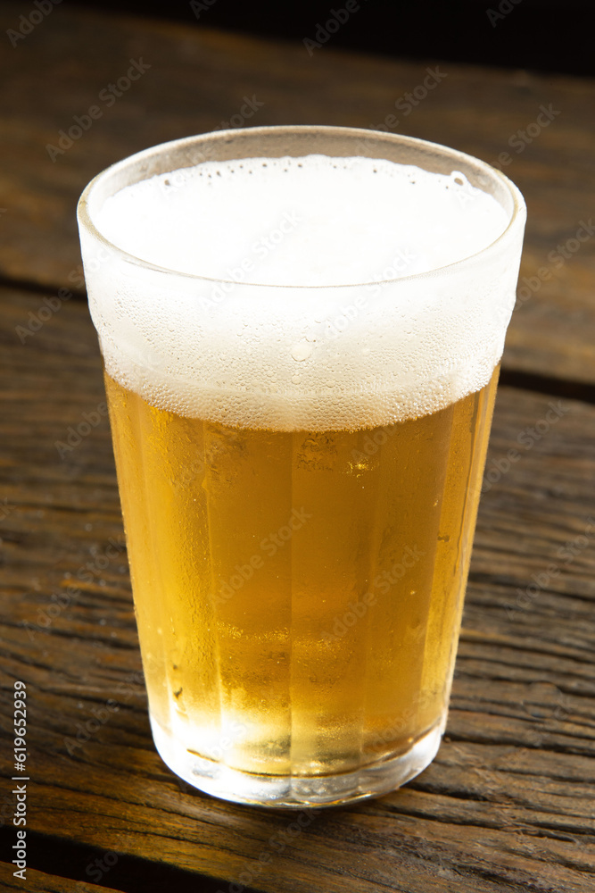 beer glass on wooden table . american cup, soviet glass beer glass on wooden table . american cup, soviet glass