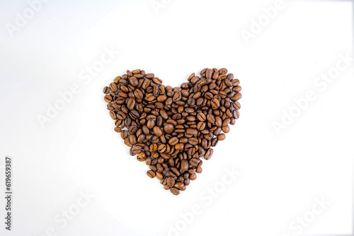 coffee beans folded into a heart on a white background