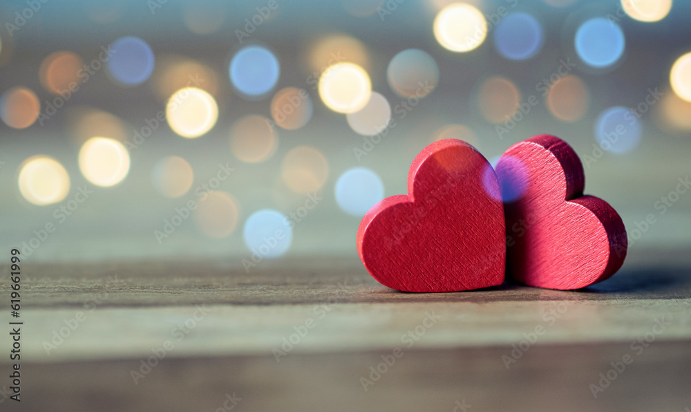 Fototapeta premium Two Wooden Red Hearts On Rustic Wood Table With Light Bokeh, The Concept of Love and Couple. Valentine's Day Concept.