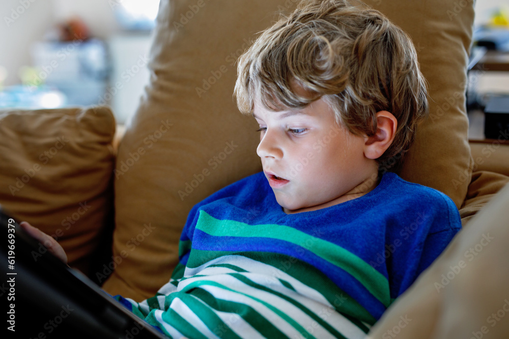 School boy with tablet computer. Schoolchild study online. Electronic device for learning, studying and playing at home. Little boy with laptop pc. Gadget and screen time for children. Kid at home. School boy with tablet computer. Schoolchild study online. Electronic device for learning, studying and playing at home. Little boy with laptop pc. Gadget and screen time for children. Kid at home.