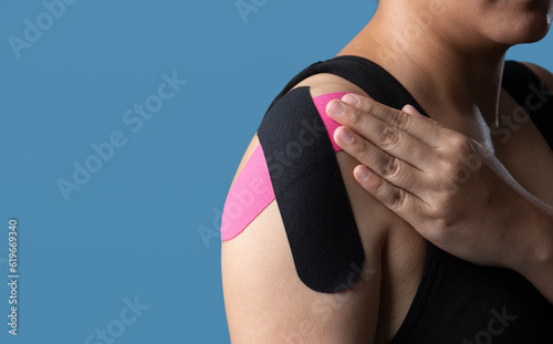 Kinesiological tape pink and black,muscle tape on shoulder,Taping problem areas and pain relief photo