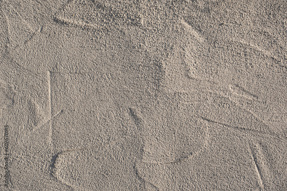 a wall with rough plaster in sunlight