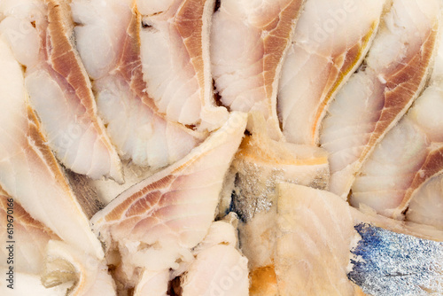 Fototapeta Naklejka Na Ścianę i Meble -  Pieces of fish fillet. Canned fish. Herring fillet close-up.