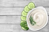 Fresh white sauce with herbs and sliced cucumber