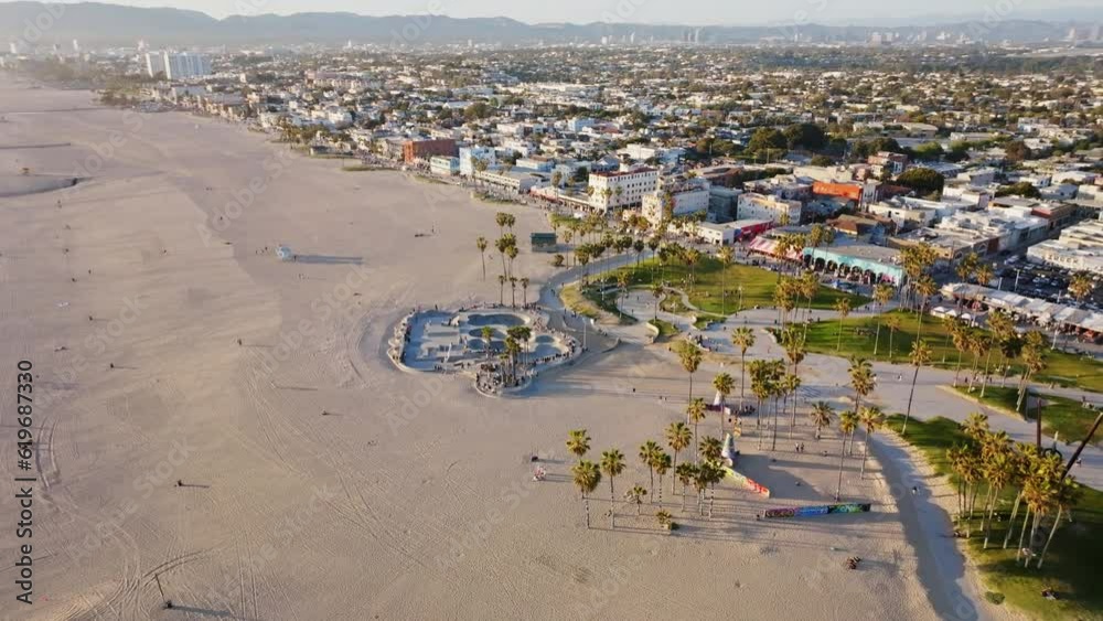 Drone above crowded Venice beach skate bowl reveal downtown Los Angeles Drone above crowded Venice beach skate bowl reveal downtown Los Angeles