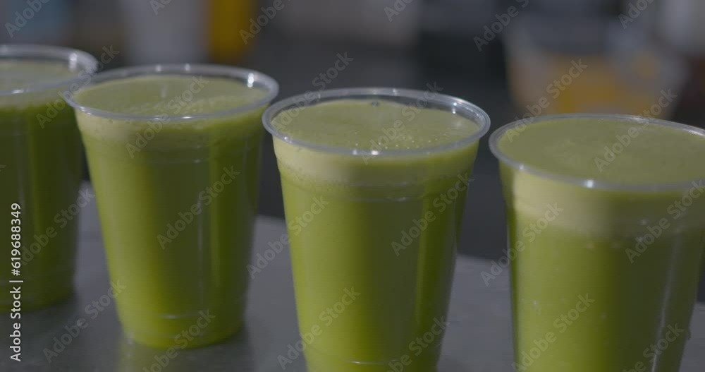Close Up Dolly of of a Row of Green Juices on a Counter Close Up Dolly of of a Row of Green Juices on a Counter