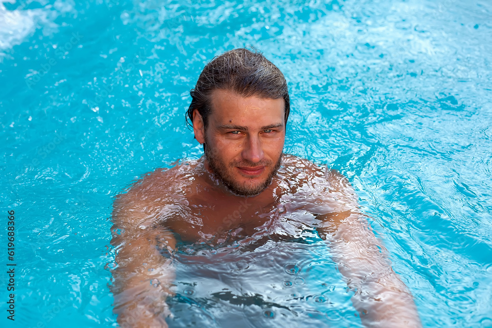 a large portrait of a young sexy tanned blue-eyed blonde bathing in the pool a large portrait of a young sexy tanned blue-eyed blonde bathing in the pool