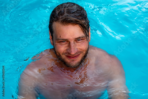 a large portrait of a young sexy tanned blue-eyed blonde bathing in the pool © Тамара Киреева