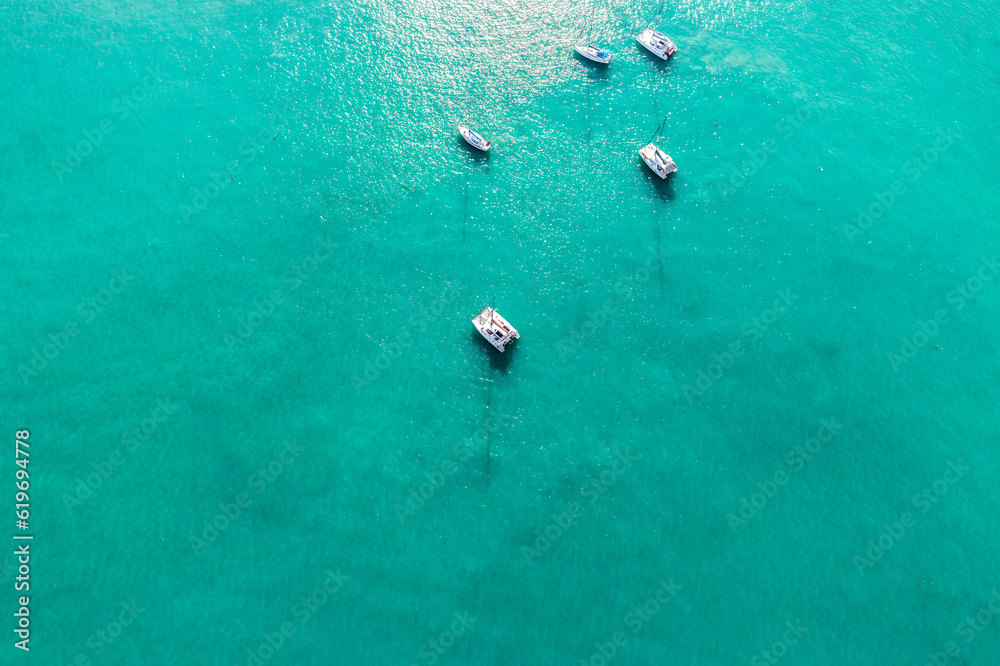 Yacht boats shot from above by drone in Phuket. Yachts on sea blue (Viridian) background.