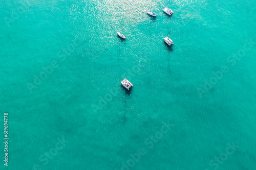 Yacht boats shot from above by drone in Phuket. Yachts on sea blue (Viridian) background. photo