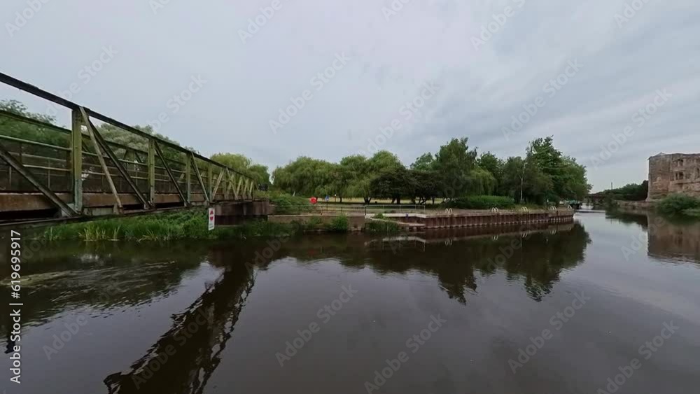 Push in shot of the bridge and the park on the River Trent in the town of Newark-On-Trent, UK Push in shot of the bridge and the park on the River Trent in the town of Newark-On-Trent, UK