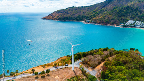Fototapeta Naklejka Na Ścianę i Meble -  Wind turbine on mountain and blue ocean background with copy space for text.
