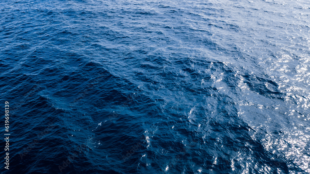 blue ocean waves background. Water surface on ocean. copy space area for text. Reflection on the surface of the ocean on a calm day.