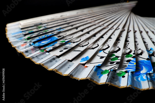 hand painted white fan isolated on black background