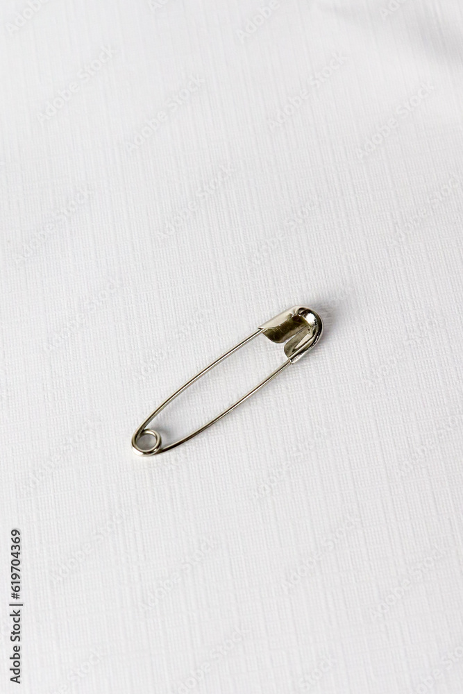 a single pin on white background. Safety Pin for blanket with standard size. isolated on white background a single pin on white background. Safety Pin for blanket with standard size. isolated on white background