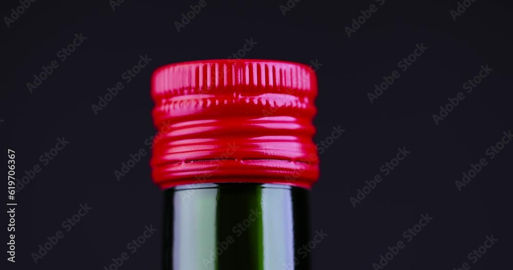 fresh olive oil in a dark green glass bottle, green bottle with squeezed olive oil fresh olive oil in a dark green glass bottle, green bottle with squeezed olive oil