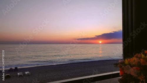 The view from the cafe of a beautiful, pink sunset. Life by the sea. 