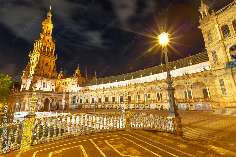 Plaza de Espana in Seville, Andalusia, Spain, is a Renaissance building that overlooks Guadalquivir river. It is a popular landmark, especially at night when the scenic Spain Square is illuminated.