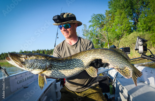 Angler with big lake pike