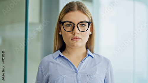 Free Download Young blonde woman business worker standing with arms crossed gesture and serious expression at office - GFXLoad