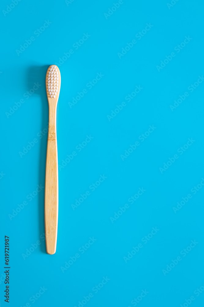 Natural eco-friendly bamboo brush on a blue background, copy space. Natural eco-friendly bamboo brush on a blue background, copy space.