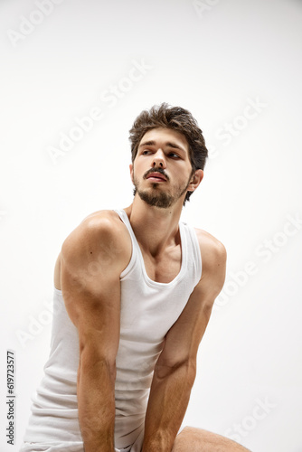 Muscular male fashion model wearing cotton underwear posing isolated over white background. Concept of men's health, beauty, fitness, fashion.