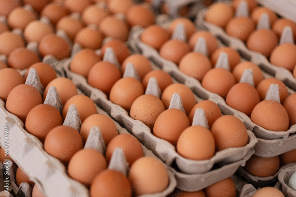 Countless brown eggs packaged up and ready to sell at a farmers market. Countless brown eggs packaged up and ready to sell at a farmers market.