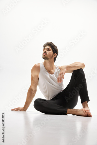 Young handsome Caucasian man wearing homewear posing over white studio background. Concept of men's health, beauty of male body, fashion, ad