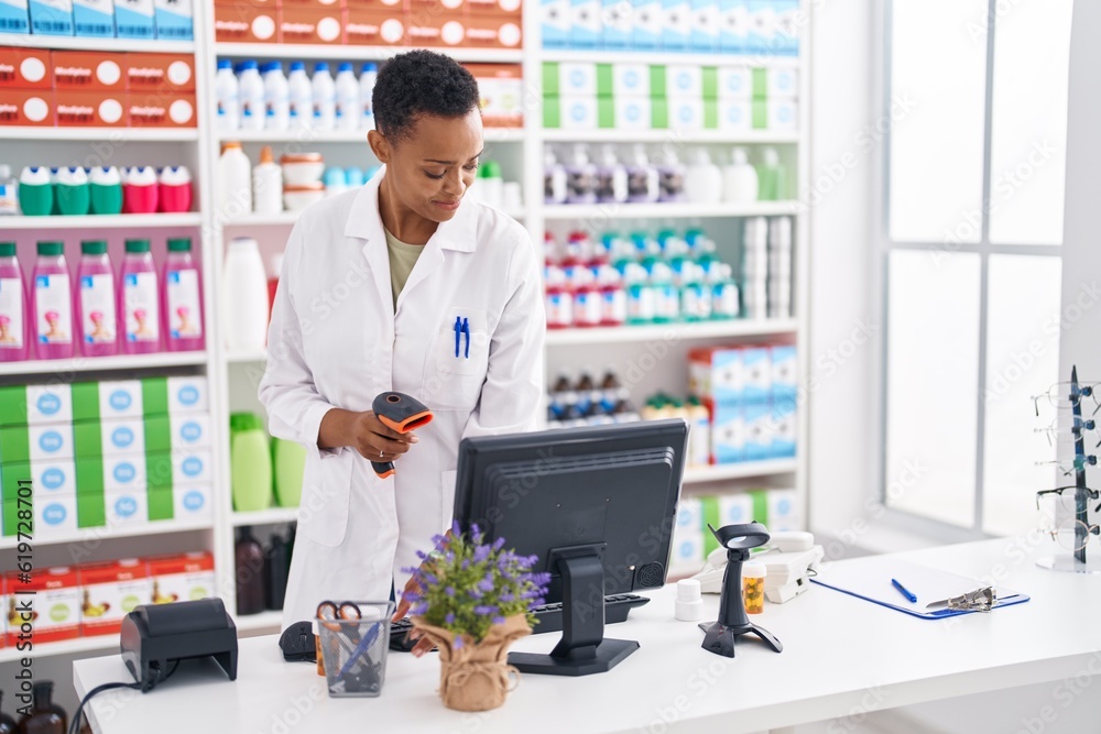 African american woman pharmacist scanning pills bottle at pharmacy