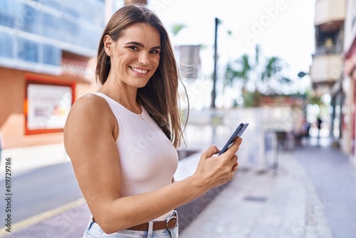 Free Download Young beautiful hispanic woman smiling confident using smartphone at street - GFXLoad