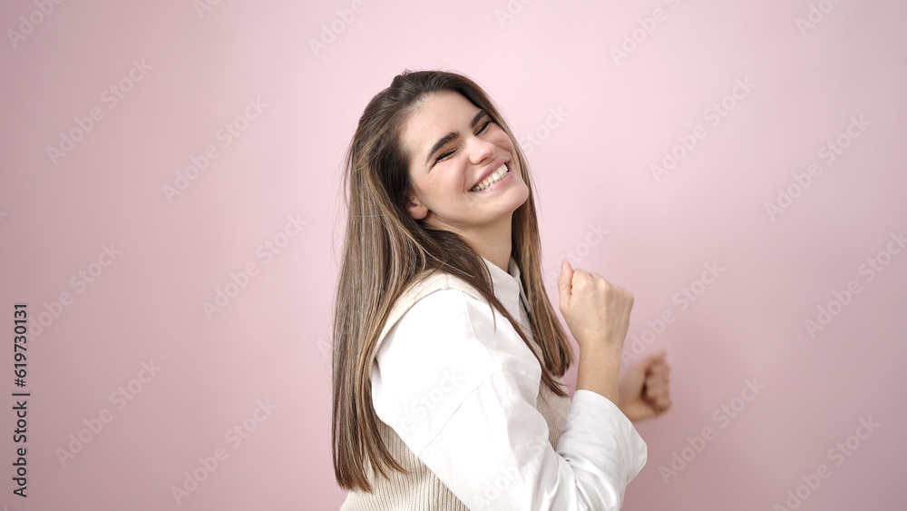 Young beautiful hispanic woman smiling and dancing over isolated pink background