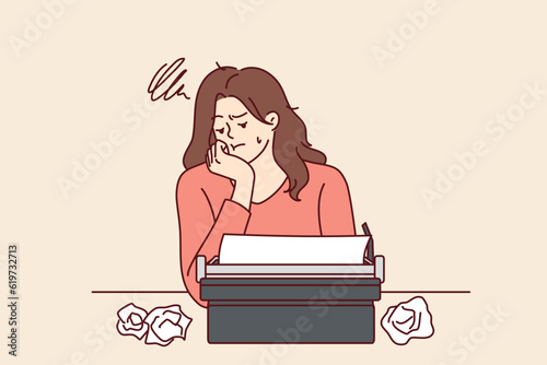 Woman with typewriter feels sad about lack of inspiration and professional burnout in career as writer. Girl writer uses vintage equipment and gets upset after making mistake in text