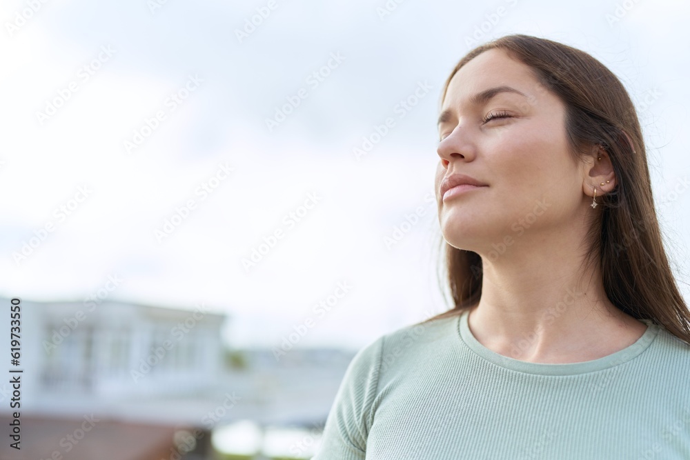 Young beautiful woman breathing with closed eyes at seaside Young beautiful woman breathing with closed eyes at seaside