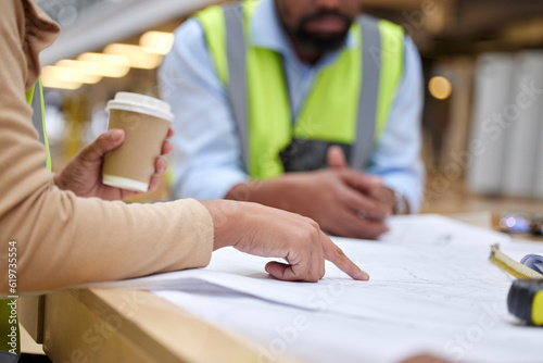 Construction, meeting and people with blueprint for planning with paperwork, illustration and document. Engineering design, teamwork and hands of workers on floorplan for building renovation on site photo