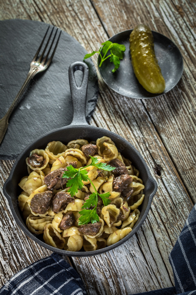 Italian pasta shells with beef sauce in cast iron pan. Italian pasta shells with beef sauce in cast iron pan.