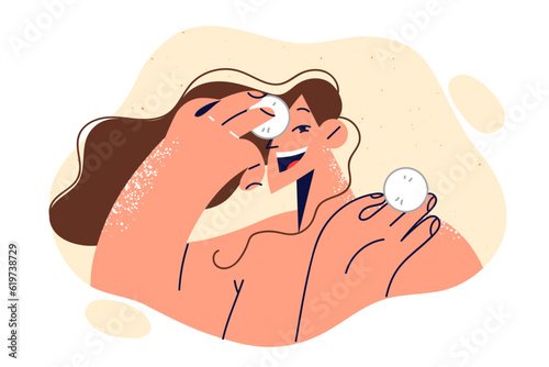 Woman uses cotton pads to treat face and fight wrinkles or remove excess makeup before bed.