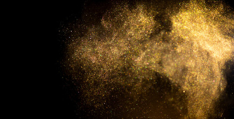 Golden sparks, Christmas and New Year glittering stars swirl on black bokeh background, backdrop with sparkling gold, holiday garland, magic glowing dust, lights. Gold Abstract Glitter Blinking sparks
