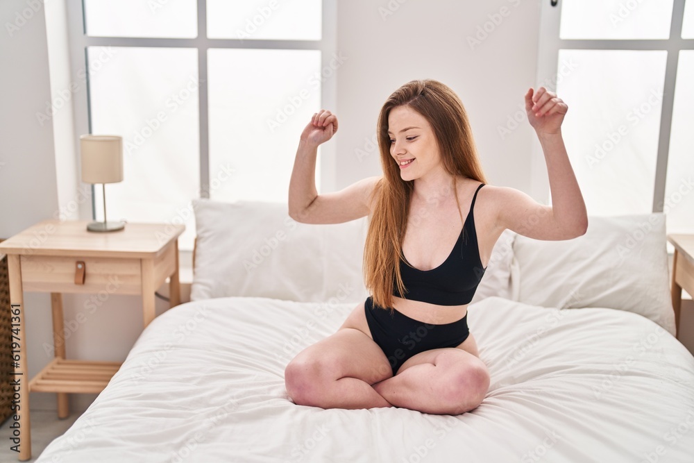 Young caucasian woman smiling confident sitting on bed dancing at bedroom Young caucasian woman smiling confident sitting on bed dancing at bedroom