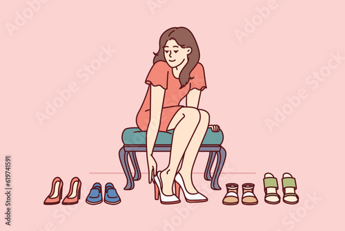 Shopaholic woman is trying on shoes in store choosing right high heels for going to party. Girl visitor of fashion boutique with shoes who loves shopping and wants to change wardrobe